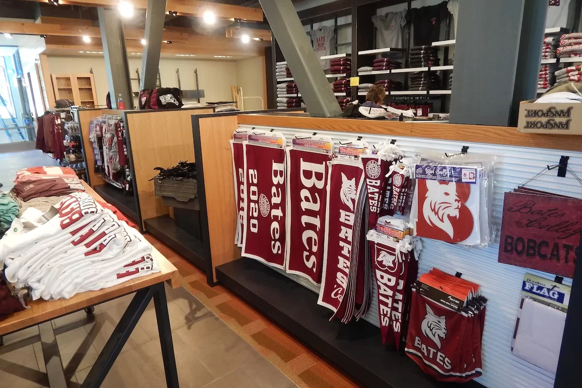 The work of unpacking and displaying merchandise in the College Store is well underway on July 21.  (Doug Hubley/Bates College)