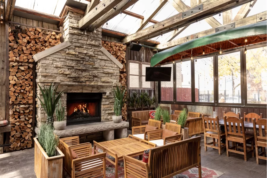 Fireplace patio with tables for guests.