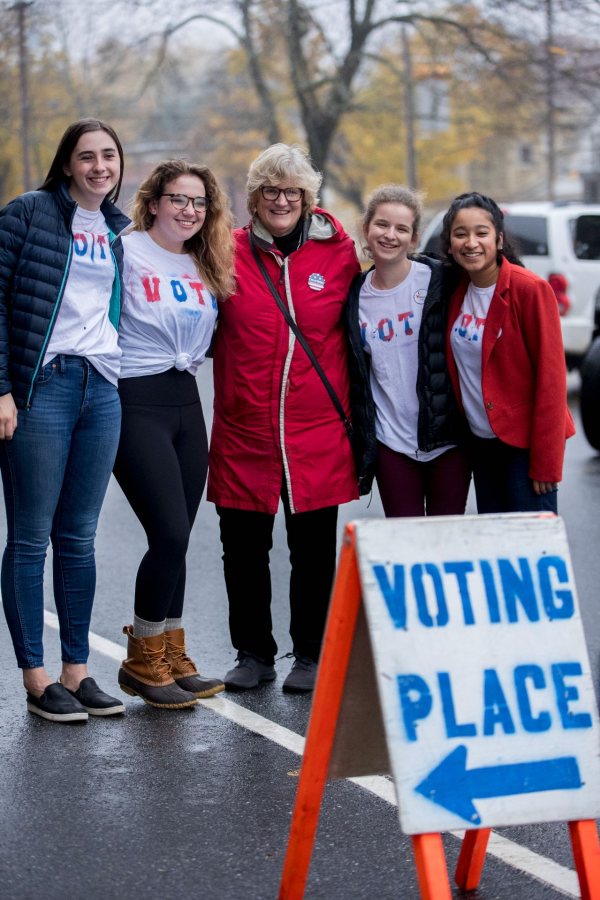 President Clayton Spencer escorts a group of Bates students to the polls on election day, Tuesday, Nov. 6..In an effort spearheaded by Bates Democrats, Bates Republicans, and the Harward Center for Community Partnerships, Bates students led a bipartisan effort to get out the vote. Volunteers led walking groups from Commons on the hour and every 15 minutes during peak times to the Lewiston Armory on Central Avenue.Student IDs:In red jacket, Maya SeshanIn blue jacket with blue jeans, Ella WesterfieldIn maroon pants, Elise GrossfeldIn glasses, long blondish hair, tied VOTE shirt and bean boots, Maya ChessenOn scooter, Michael RatzimbazfyStudent in blue hood, Harkirat Lally Student in aqua blue jacket, Elektra Smicka