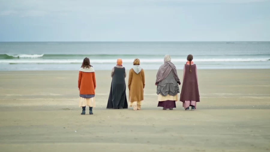 members of artist collective on beach, standing together