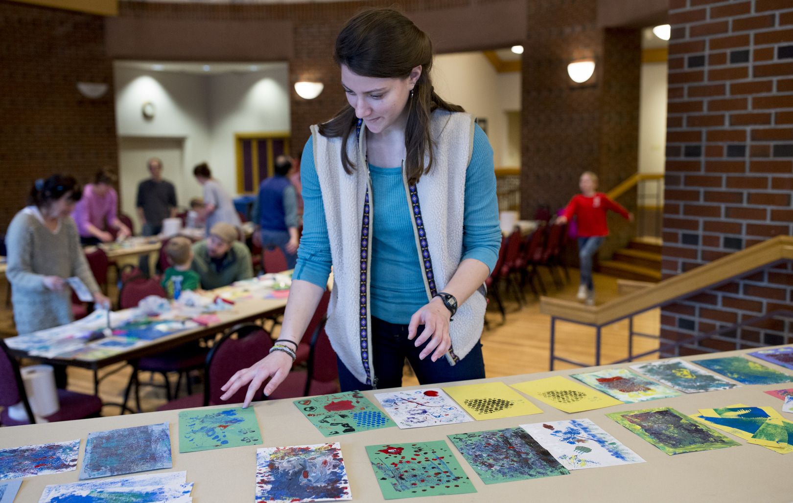 Hannah Gottleib ’16 of Brookline, Mass., leads a printmaking program she organized for 15 schoolchildren and their families. After looking at prints in the Bates Museum of Art, they used tools like broccoli and bubble wrap to create their own art at the Benjamin Mays Center. Gottlieb is a history major and museum education intern. (Phyllis Graber Jensen/Bates College)