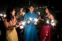 Inside the Muskie Garden, Jhansi Kolli ’21 of Murfreesboro, Tenn.; Armaan Mecca ’21 of Chennai, India; and Prarthana Mocherla ’21 of Old Tappan, N.J., light sparklers to celebrate Diwali. (Theophil Syslo/Bates College)