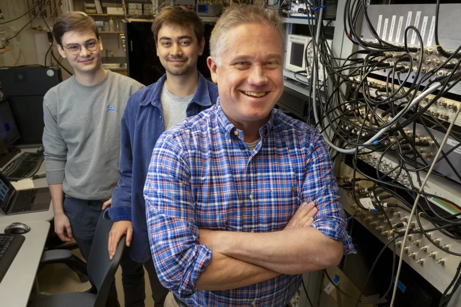 Professor of Physics Nathan Lundblad has received an award from NASA. He is collaborating with several students on the research and is shown here in his Carnegie Science Lab (Carnegie 146) with two of those students, Kona Lindsey ’23 of Colorado Springs, Colo., and Elias Veilleux ’23 (I gray shirt with glasses) of Orono, Maine Kona is shown with his laptop that display research images. Kona writes: “The image seen on my laptop is from an experiment run in the Cold Atom Lab on the International Space Station (ISS). It shows an ultracold gas bubble composed of rubidium atoms. The ring that is visible indicates that the atoms are occupying a shell, or bubble structure. You can see that the inside of the ring has few atoms, meaning the structure is truly hollow.”