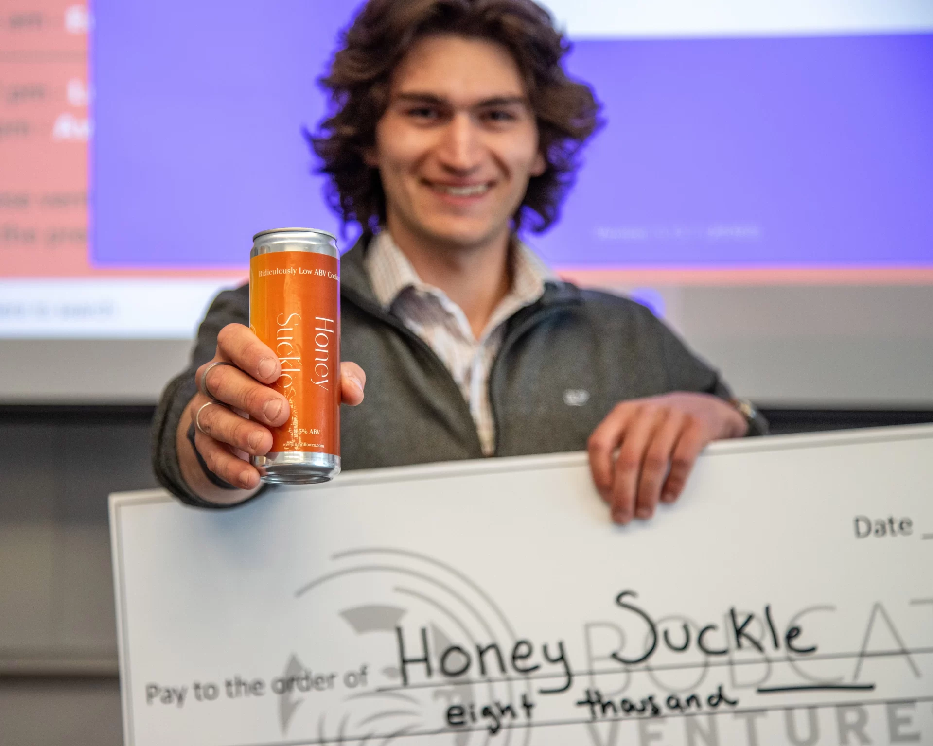 Bates students competed in Bobcat Ventures on April 6, presenting in front of alumni entrepreneurs for cash prizes for their business ideas. The top prize of $8,000 was won by Aidan Stark-Chessa for his non-alcoholic drink, HoneySuckle. Stark-Chessa poses with his check and his product, HoneySuckle.