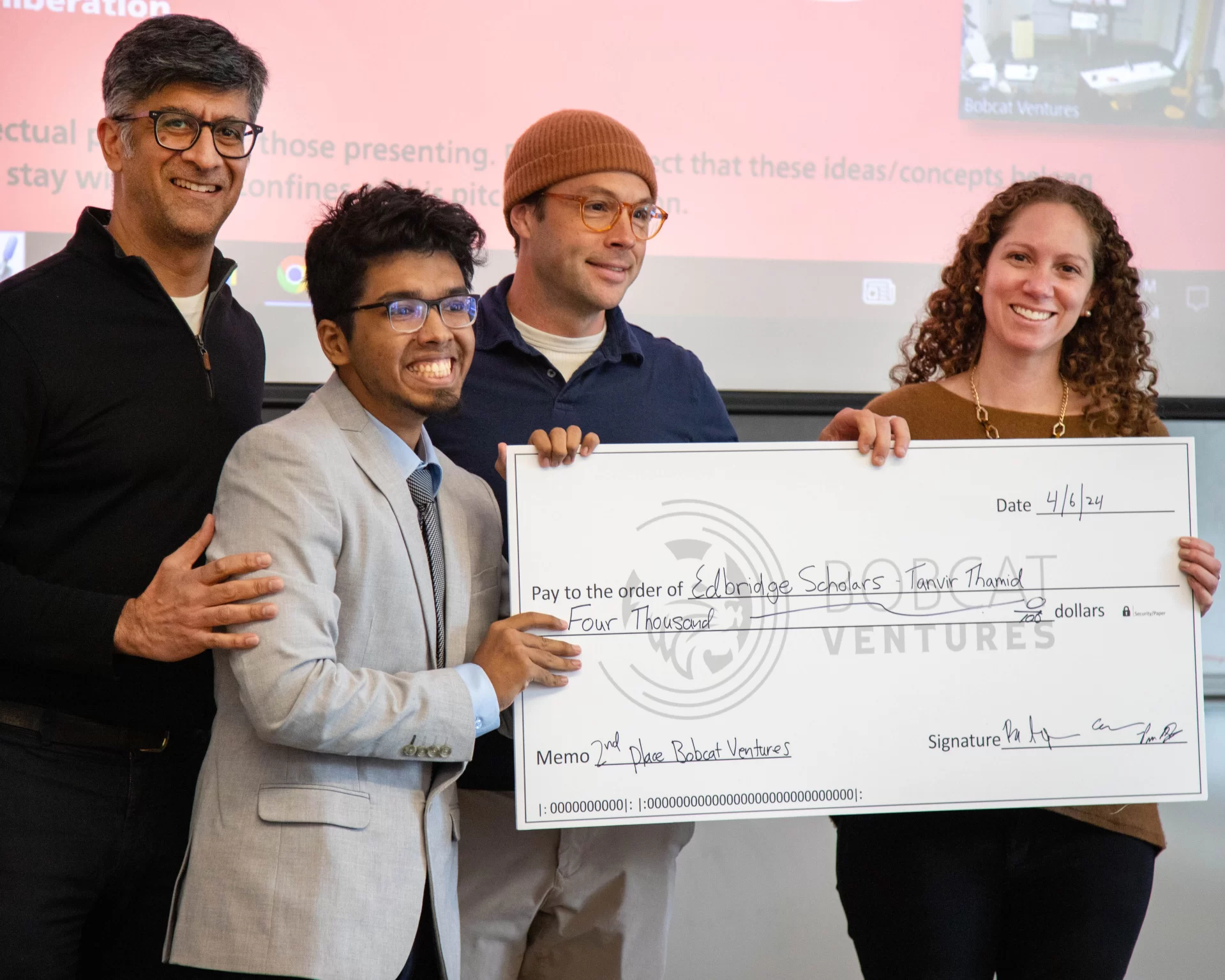 Bates students competed in Bobcat Ventures on April 6, presenting in front of alumni entrepreneurs for cash prizes for their business ideas. The top prize of $8,000 was won by Aidan Stark-Chessa for his non-alcoholic drink, HoneySuckle. Tanvir Thamid '26 poses with the judges and his $4,000 check for his idea, Edbridge Scholars.