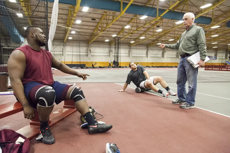 March 8, 2016: Fereshetian works with Nick Margitza ’16 and Adedire Fakorede ’18 in their final tuneup before departing for the NCAA Division III Indoor Track and Field Championships. (Josh Kuckens/Bates College)