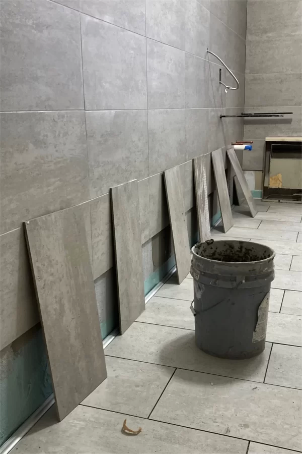 Tile installation in a 96 Campus Avenue restroom. (Doug Hubley/Bates College)