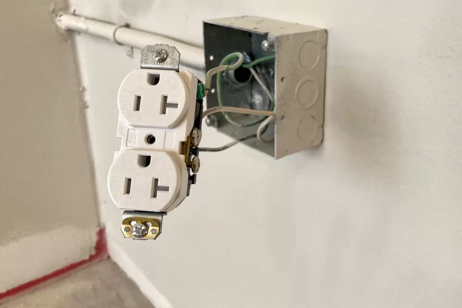 An electrician has stepped away partway through installing an outlet in a dorm room at 96 Campus Avenue. (Doug Hubley/Bates College)
