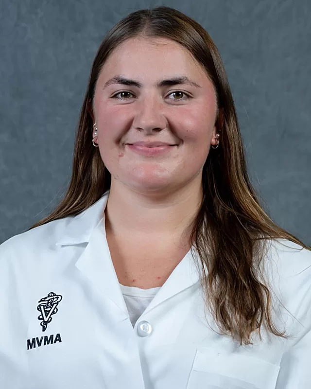 Gabrielle Smart '23 smiles in "headshot" photo with MVMA white lab coat.