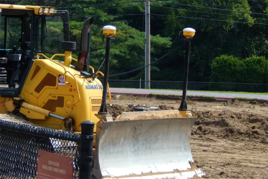 The yellow gizmos topping the masts on this Shaw Bros. bulldozer are transceivers for the GPS system that guides the operator at Russell Street Field. (Doug Hubley/Bates College)