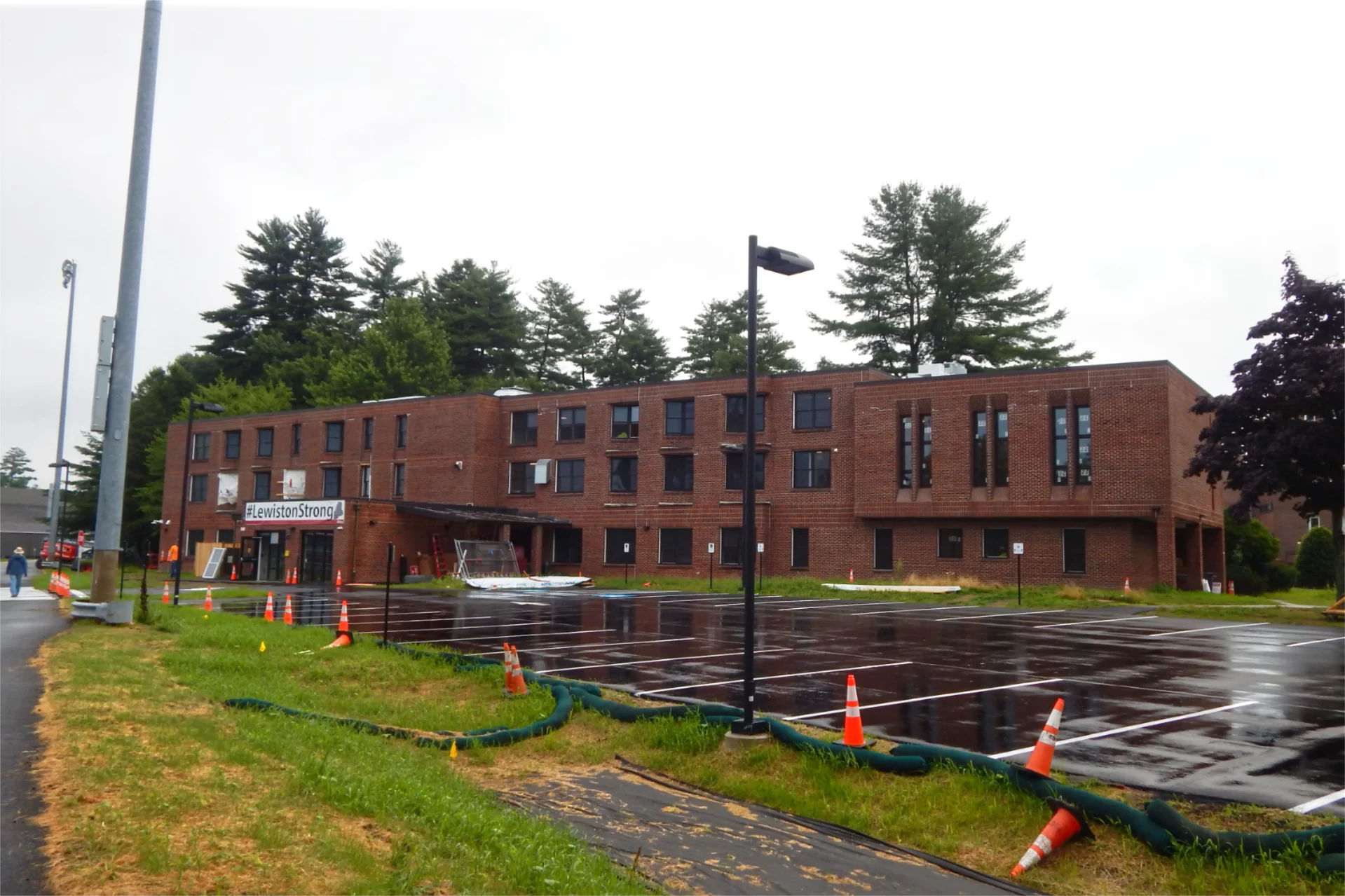 The site fence that enclosed 96 Campus Avenue for much of 2024 was removed in late July, affording long views of Bates’ newest student residence. Parking lot paving, striping, and installation of signage were all completed around the same time. In the foreground is a swale to capture storm runoff. (Doug Hubley/Bates College)