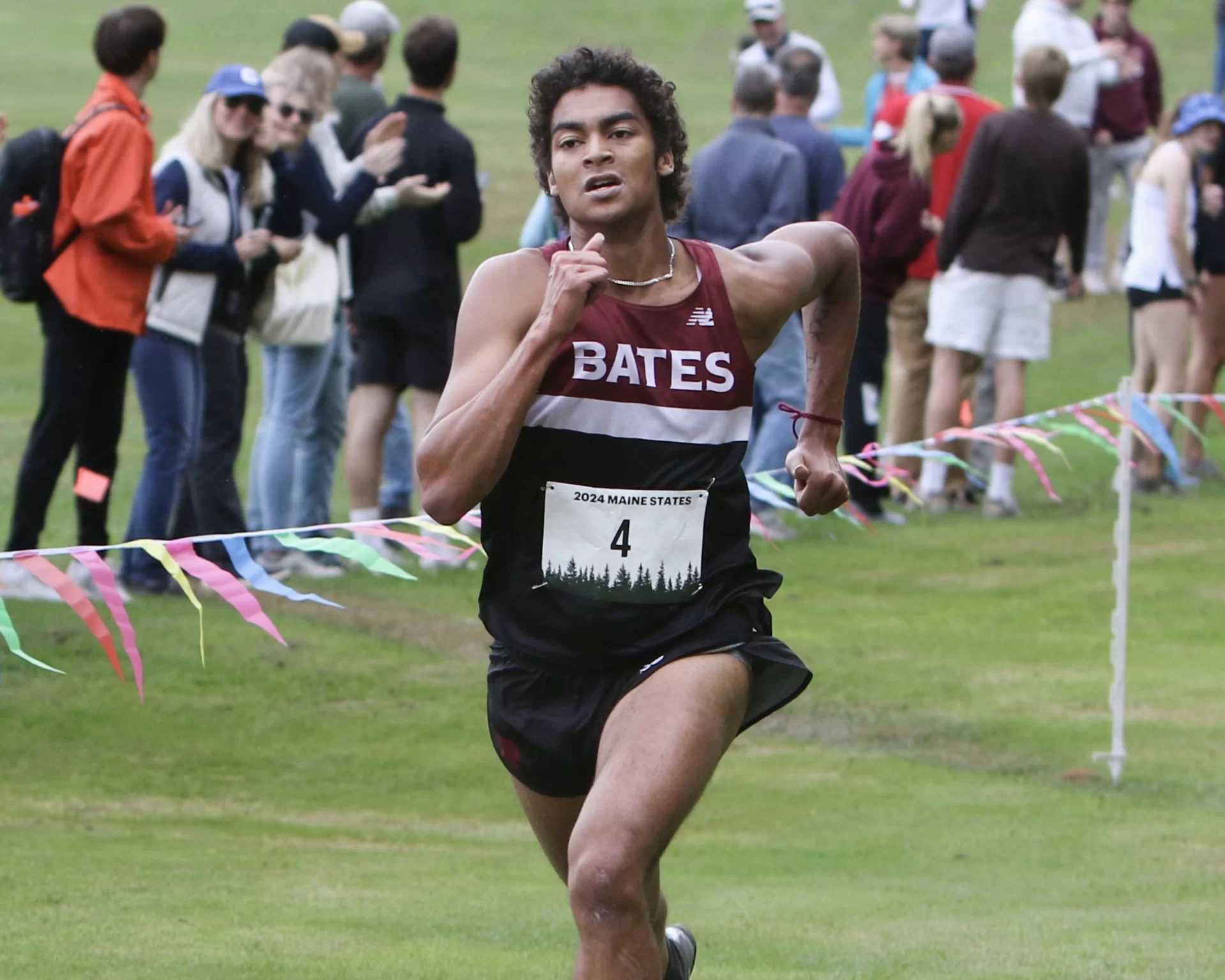 cross country runner on grass.