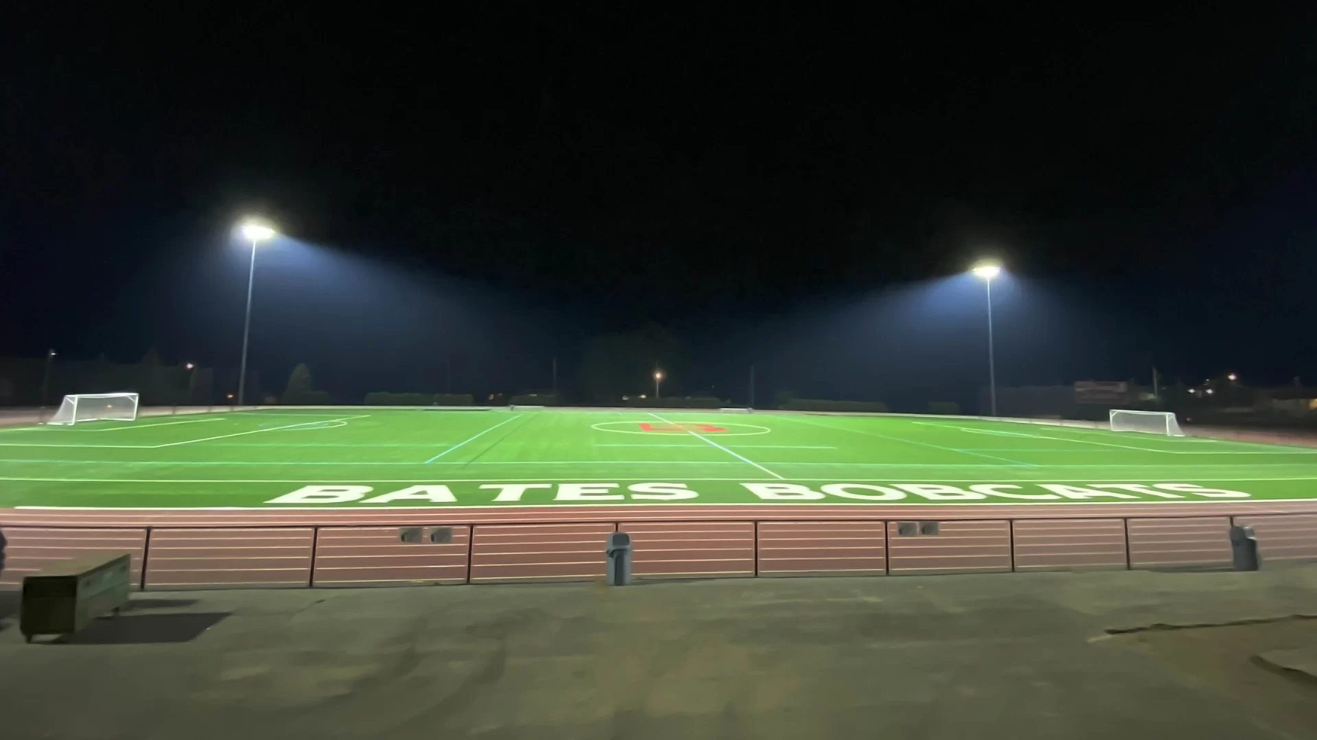 athletic field at night illuminated by stadium lights