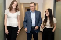 Linh Vu ’26 , a double major in mathematics and economics from Hanoi, and environmental studies major Drew Williams ’25 of Guilford, Conn., pose for photographs at Promethos Capital, a Boston-based investment boutique focused on global equity investments with Joe Sylvester ’90, founder, director of research and managing partner, and Ifka Klaus, founder, chief investment officer, and managing partner. The two students have Purposeful Work-funded internships at the firm, located at 101 Federal Street.