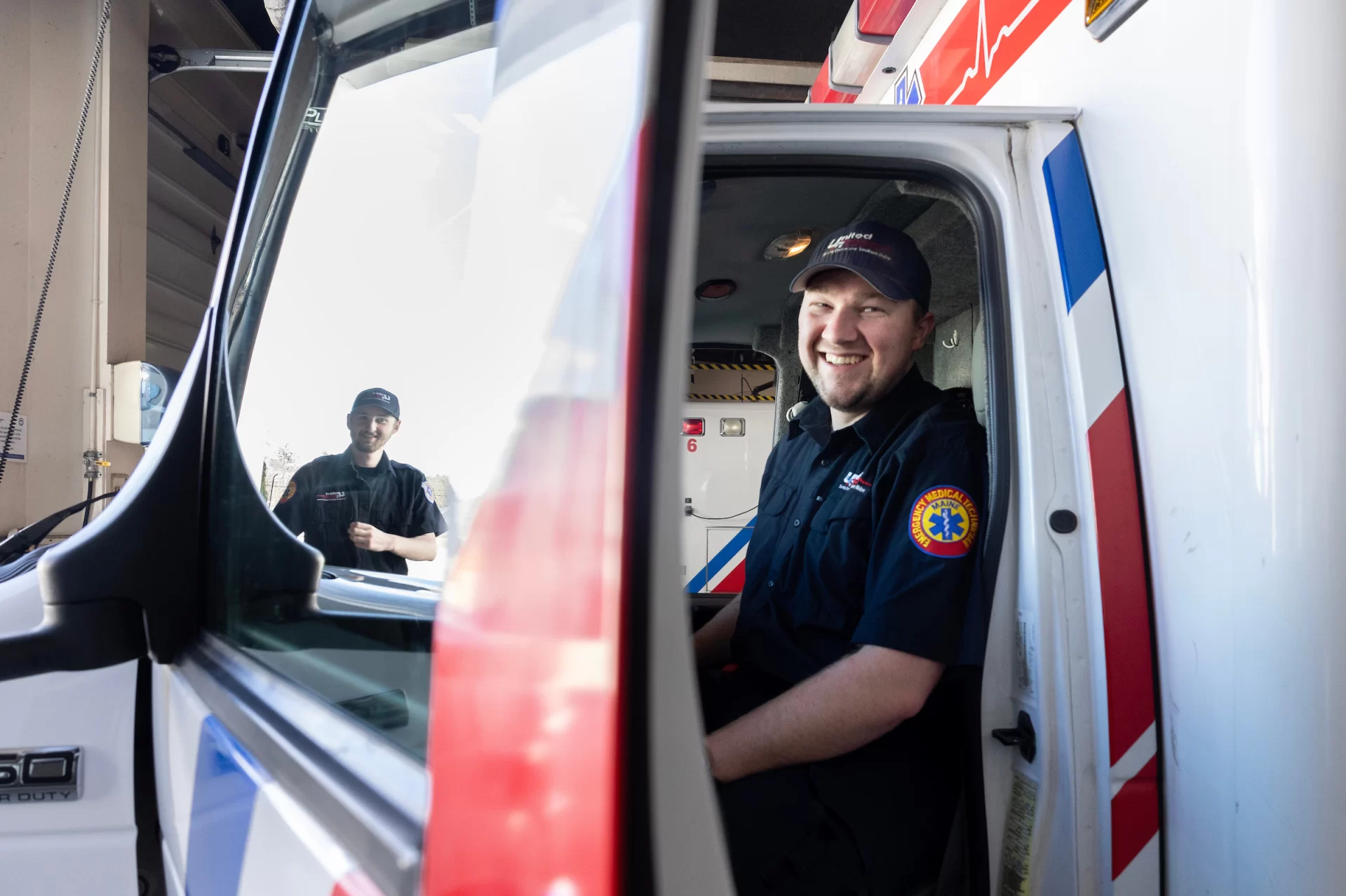 Bates EMS co-chief Ned Friedman ’24 of Park City, Utah, and Noah Bachner ’25 of Weston, Conn., work their overlapping shifts on Sunday, March 31, at Lewiston’s United Ambulance on Russell Street. Shadowing Ned (with the fuller beard and mustache) for the day is first-year Maggie Gill of Tenants Harbor, Maine. Pictured also is EMT Dakota Hern in the United kitchen.