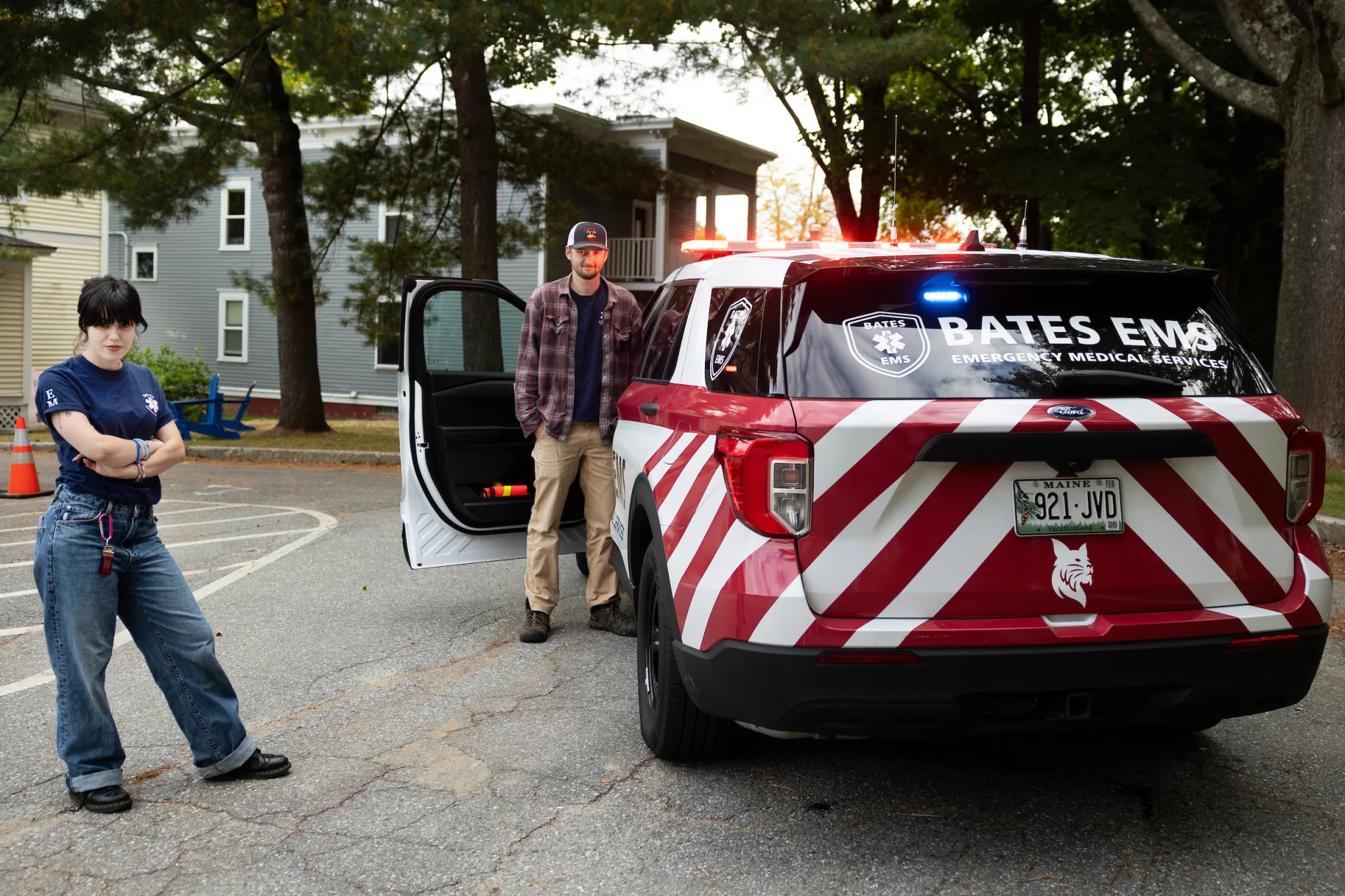 Aoife Spiesel ’26 of South Orange, N.J.,and Noach Bachner ’25 of Weston, Conn., co-presidents of Bates EMS, pose with the organization’s new vehicle in the parking lot behind Campus Safety.