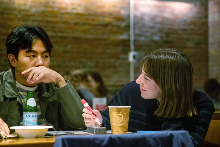 two students look at each other during trivia night