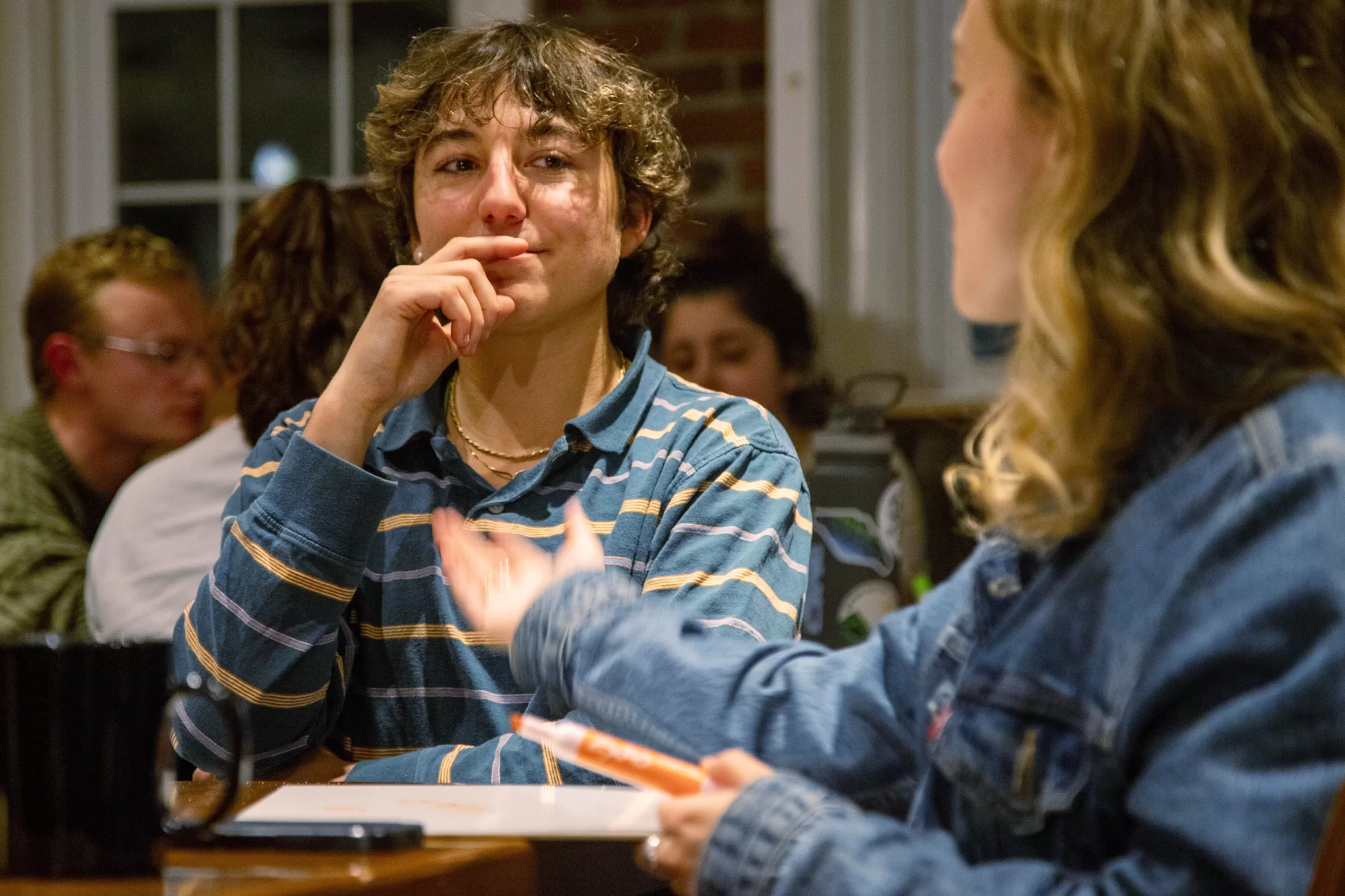 a pensive student sitting at a table