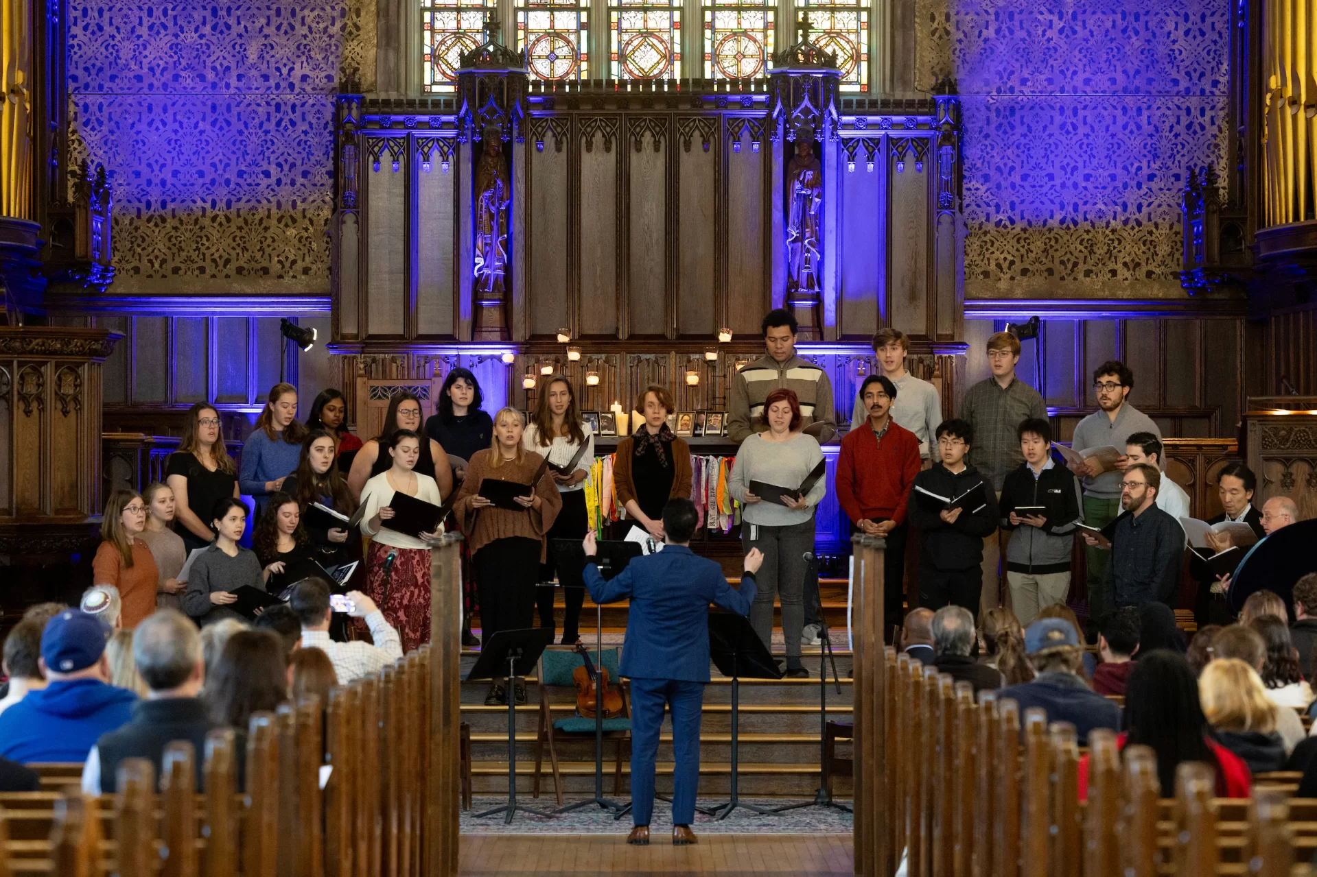 Assistant Professor of Music Zen Kuriyama directs the College Choir in a communal song for peace, "Dona Nobis Pacem" (Grant Us Peace"). (Phyllis Graber Jensen/Bates College)