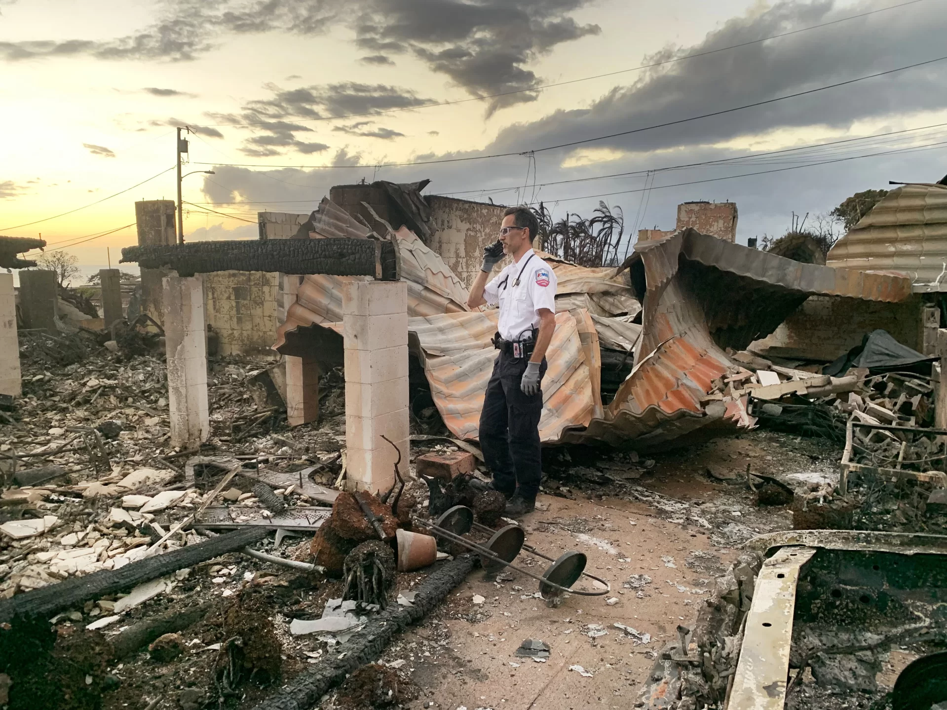 David Kingdon '98, a BEMS cofounder stands amidst debris on the island of Maui following the deadly August 2023 wildfires. 