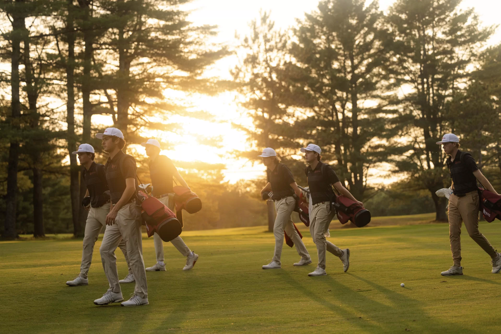 The men's golf club walks across the Martindale course during a practice.