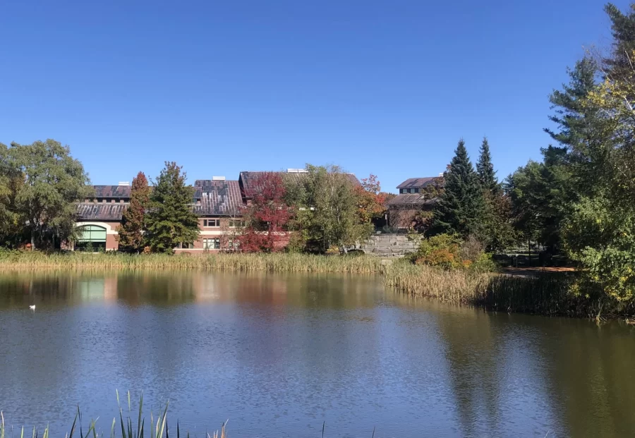 view of a pond and large academic building