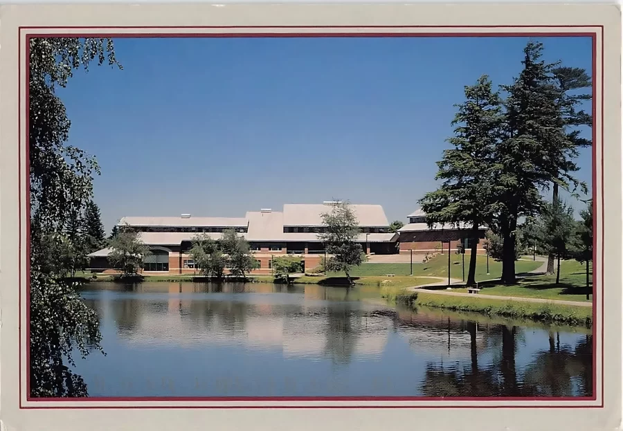 view of a pond and large academic building