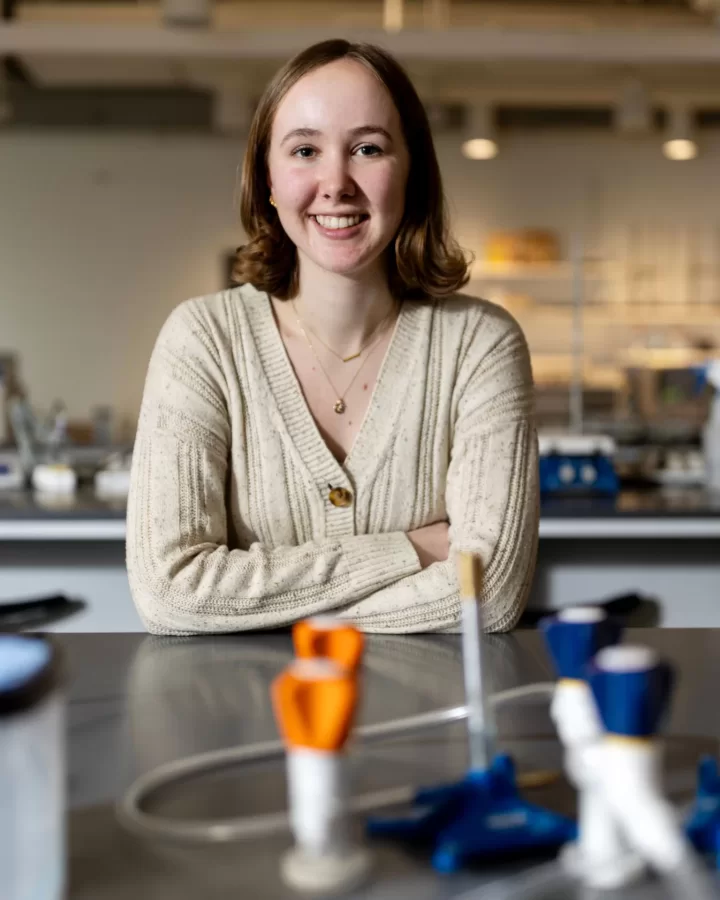 Emily Scarrow’25 of Washington, DC poses in the Bonney Science Center’s biochemistry lab for a story about her being named as a 2024winner of the Barry Goldwater Scholarship.