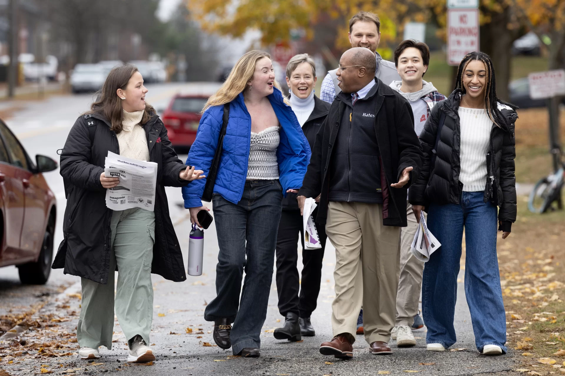 group of people walking on sidewalk