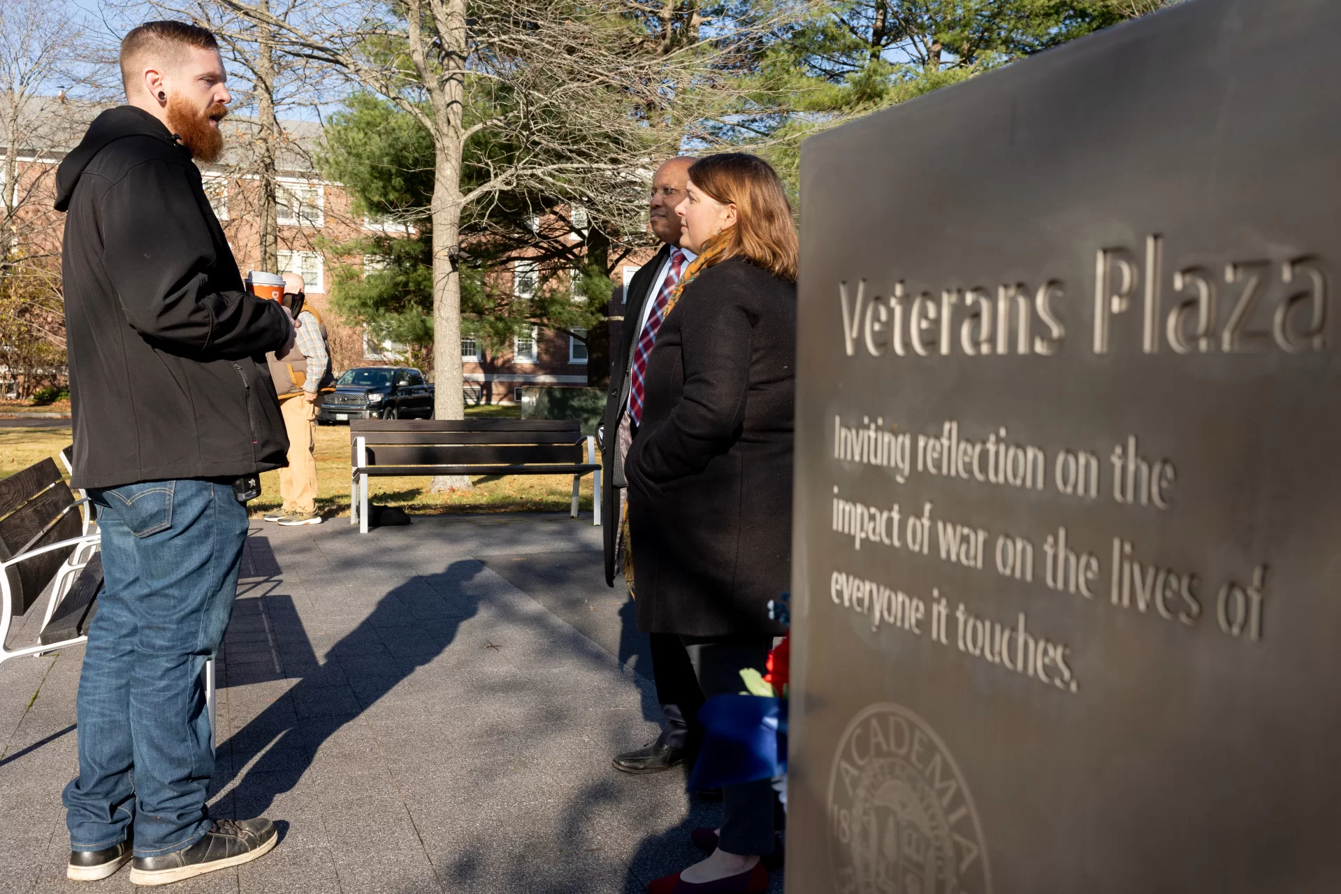 On Veterans Day, we pause to reflect and remember.

During this morning’s gathering at Bates Veterans Plaza, Joe Castonguay of Facility Services lays a flower atop one of the basalt stones that comprise the plaza centerpiece. “I learned the value of human life in combat,” said Castonguay, a U.S. Army veteran who served for 15 months in Iraq.

The Rev. Dr. Brittany Longsdorf, @bates_multifaith chaplain, guided today’s centering moment, which included reflective readings and interfaith prayers, the observing of silence, and the ritual of laying flowers to honor the service and sacrifice of veterans.

Dedicated in 2020 and located near the Benjamin E. Mays Center, the plaza honors Bates veterans and invites “reflection on the impact of war on the lives of everyone it touches.”

President Garry W. Jenkins was in attendance.