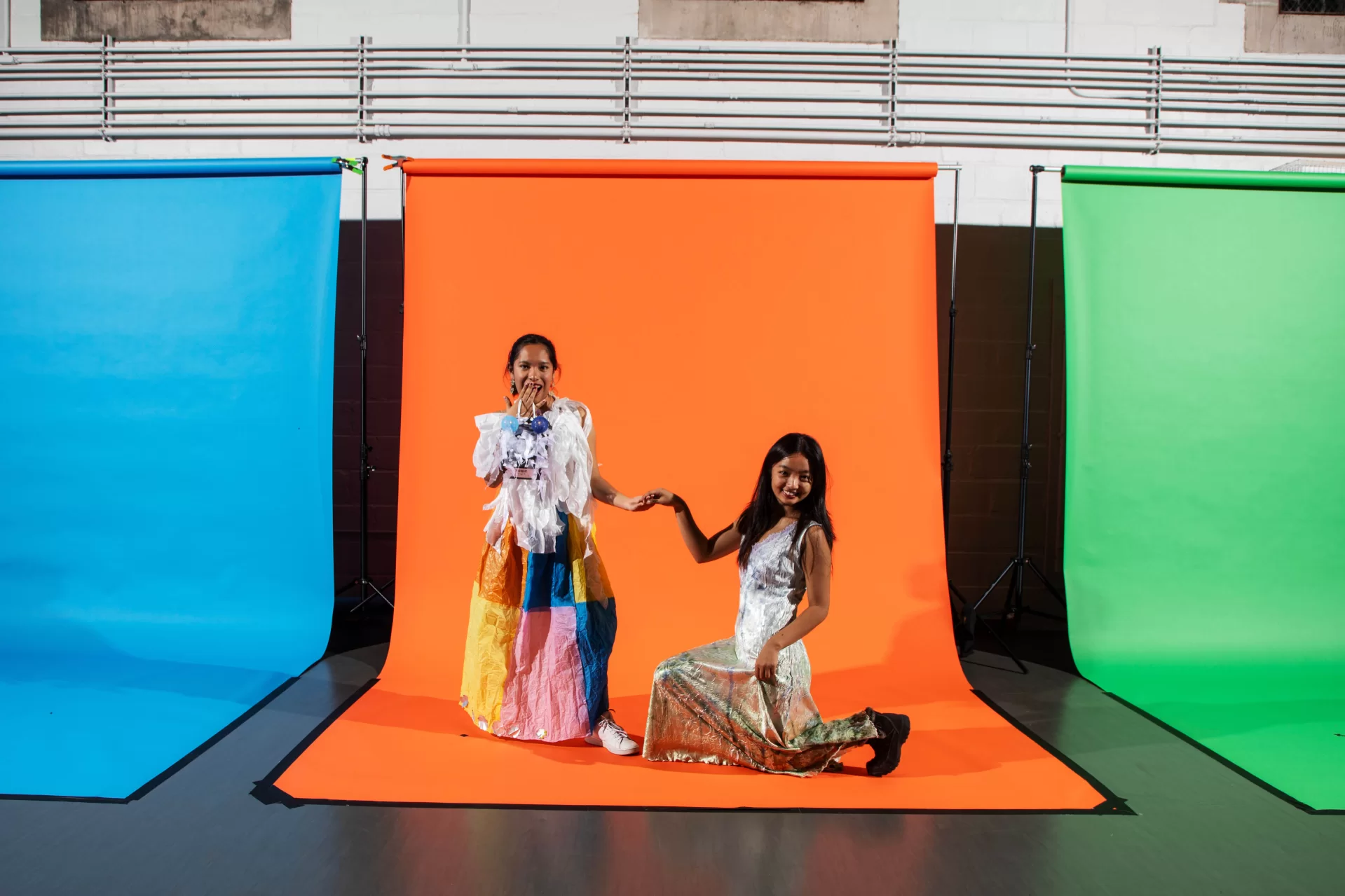 two students posing in front of a backdrop