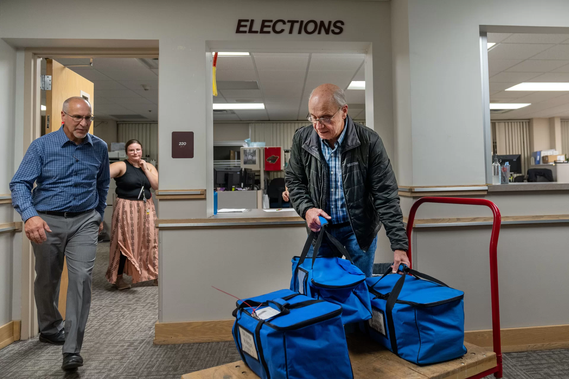 two men preparing election ballots