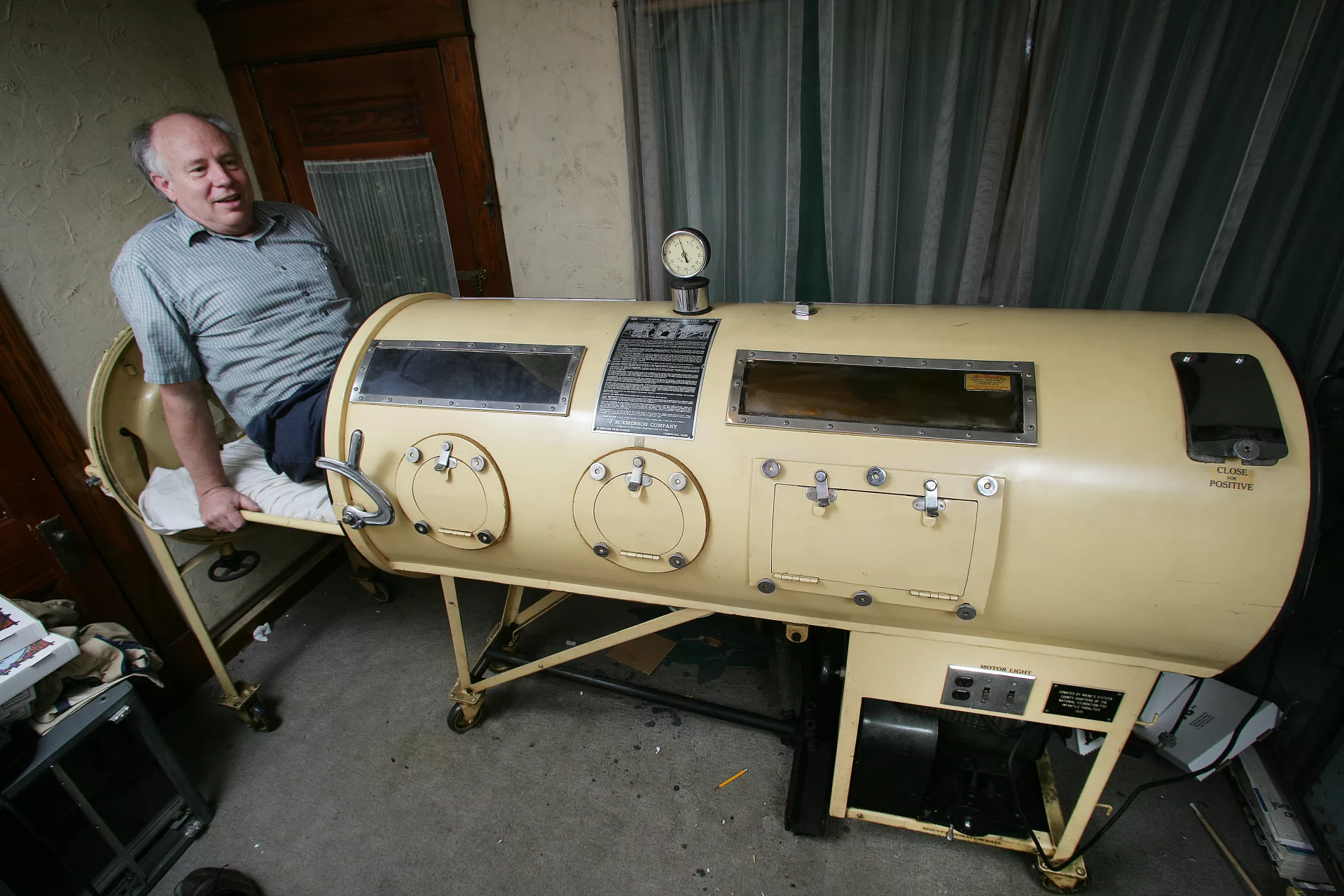 man getting into an iron lung