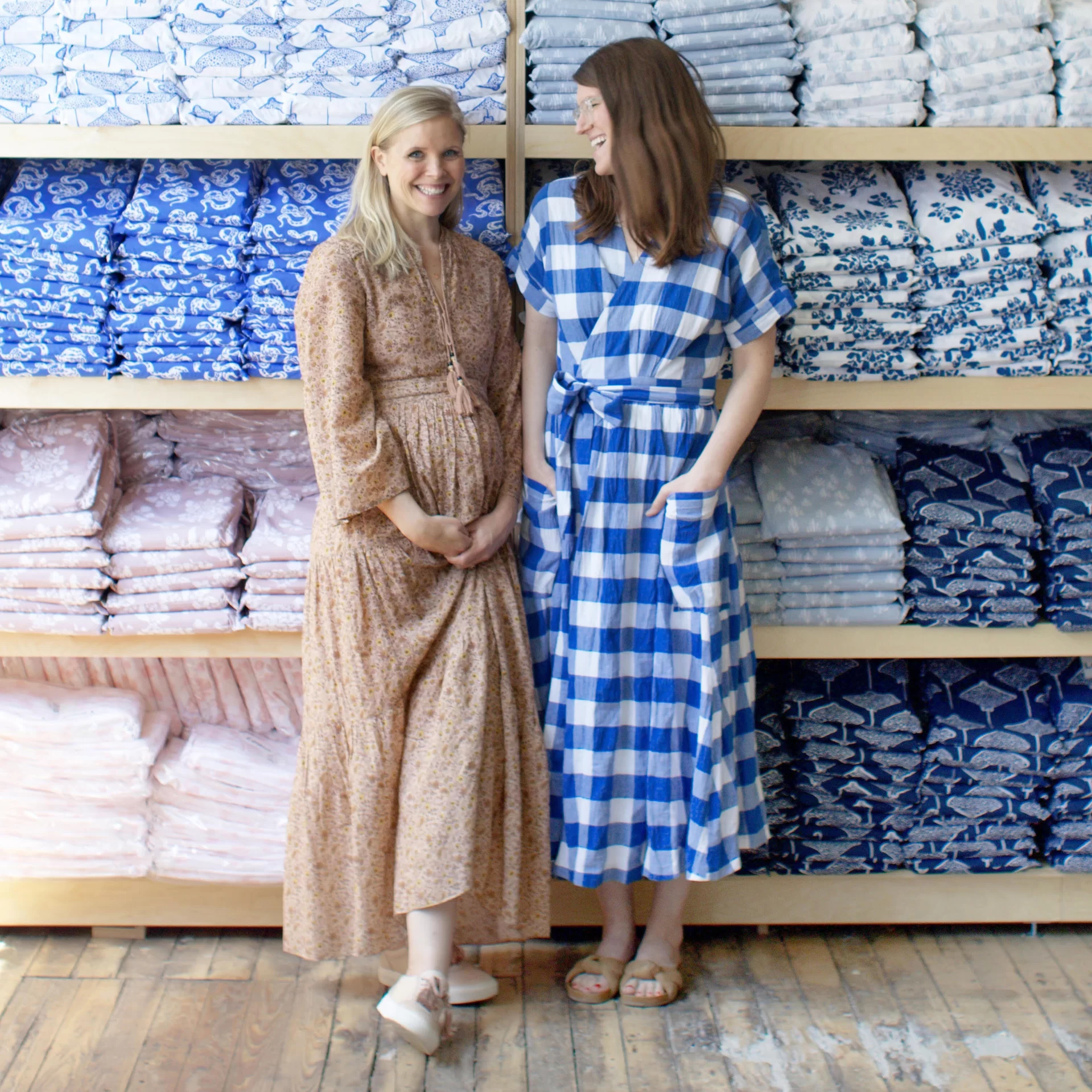 Lizzy Ott '04 (left) and Liz Libré '02 pose in front of a display of Lewis products.