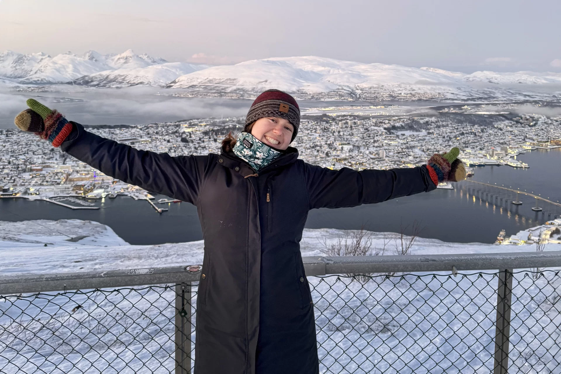 person posing with Tromsø, Norway, in background