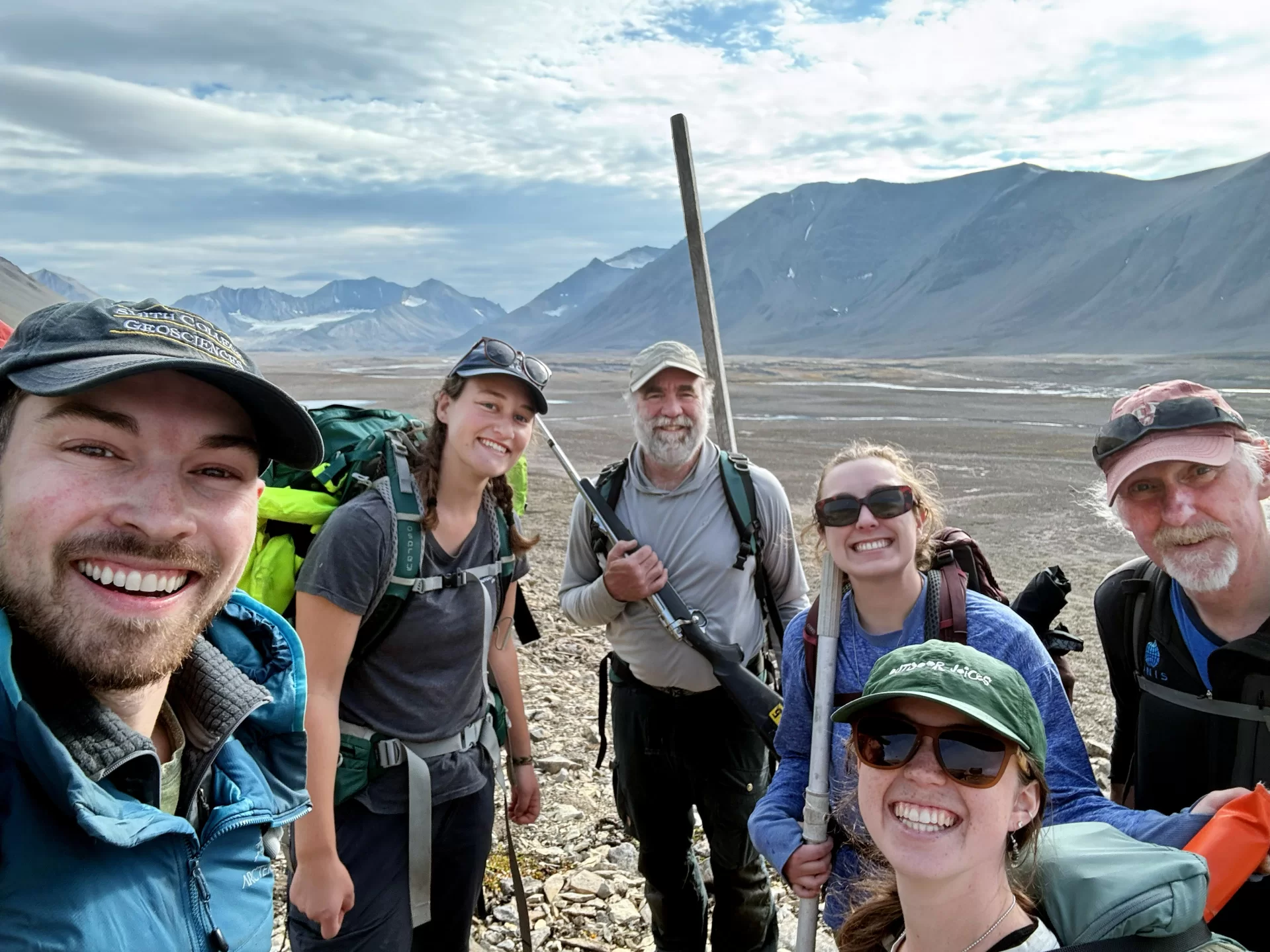 group of people posing in an arctic summer environment