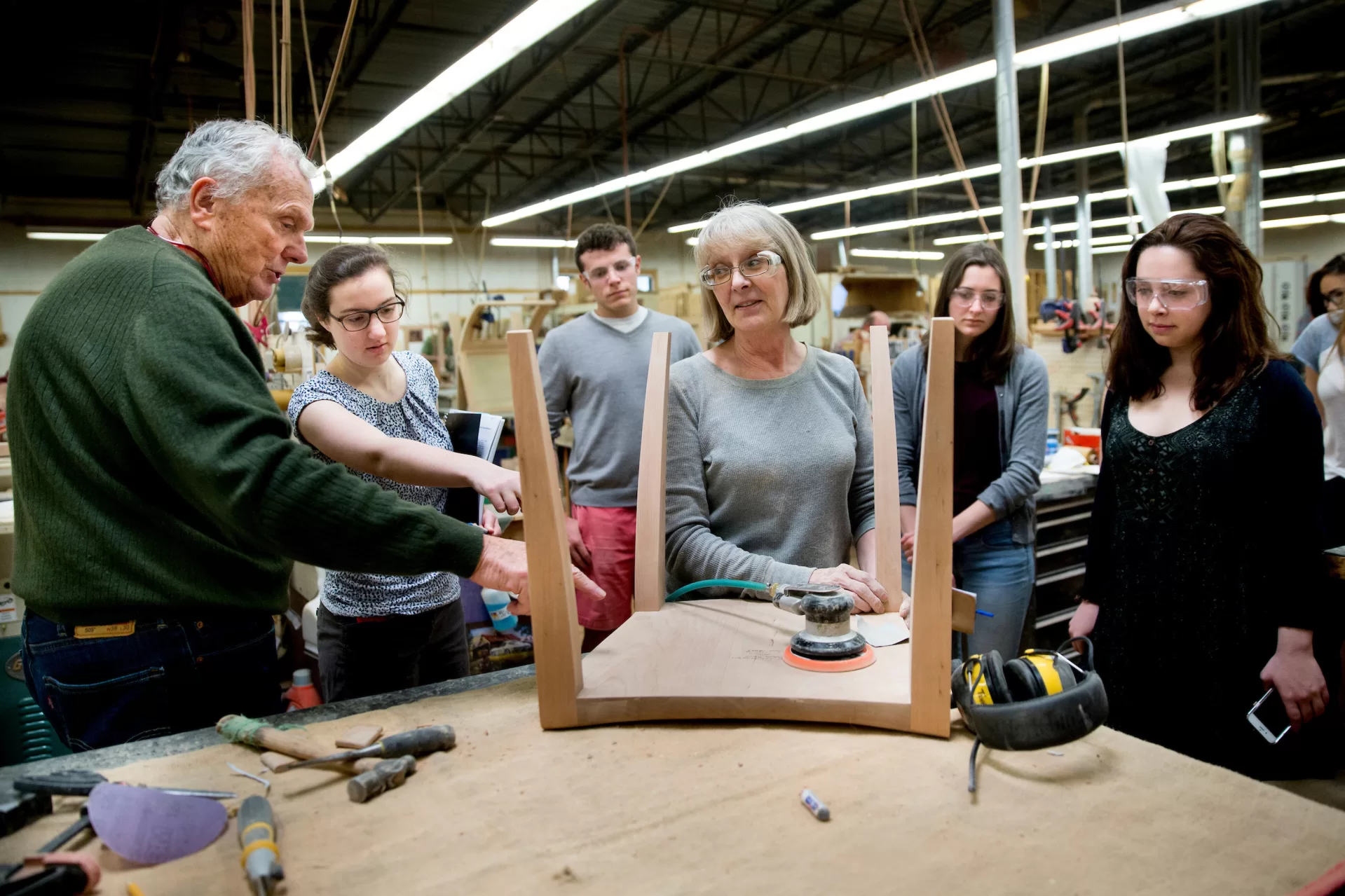 "My introduction to business was through Aristotle." -- Thomas Moser, a master craftsman whose handmade furniture beautifies public spaces around the world, explaining the importance of a liberal arts education. Students in the "Short Term Practicum: Brand Culture Building" (including Lois Masson '16 of Petit-Lancy, Switzerland, and Clarke Shipley '17 of Andover, Mass., pictured here) listened to the internationally acclaimed furniture designer as he offered them a tour of his Thos. Moser Cabinetmakers workshop in Auburn, Maine. Moser, a former speech professor and debate coach at Bates, received an honorary doctor of humane letters from the college in 2015. This course, taught by brand strategist Peter Bysshe '93, takes students behind the scenes of brand culture consultants in an effort to not only humanize intimidating large corporate cultures, but also to arm students with tools to observe, measure, and build, manage or contribute to smaller cultures in which they may find themselves after graduating.