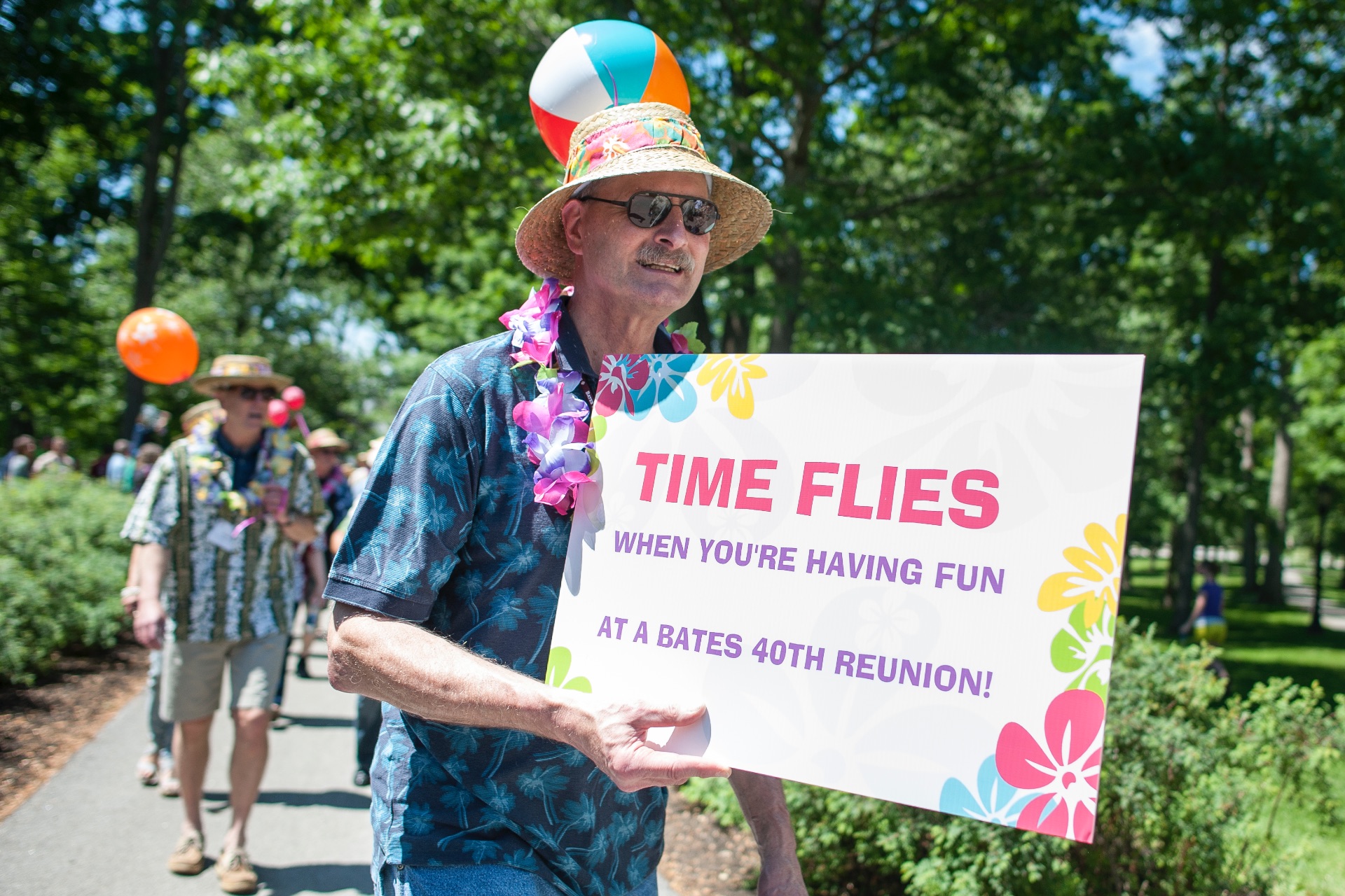 an older man with a poster at reunion