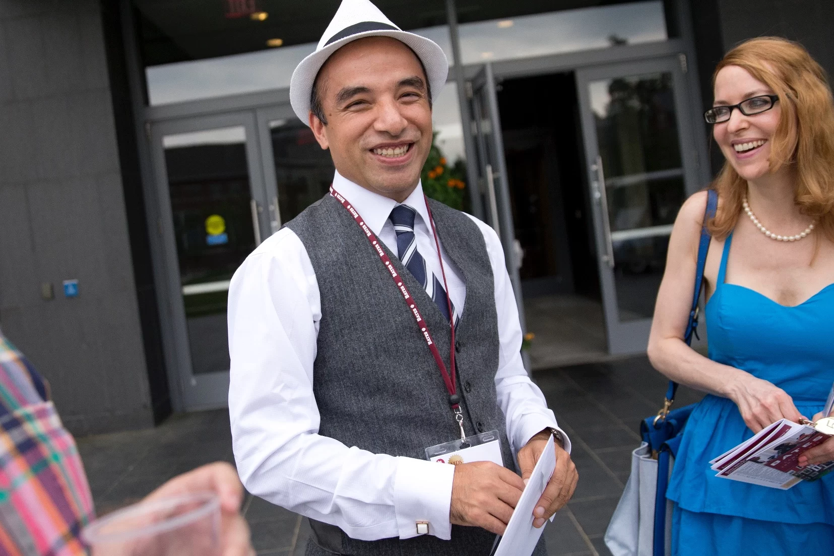 a sharp dressed man with a bates nametag